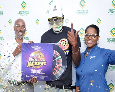 Xesus Johnston, Supreme Ventures Gaming CEO(left) and Debbie Green, General Manager IGT were present to celebrate with K. Golding, the first winner and first millionaire from the Money Time Jackpot promotion. Golding won $4.2M with a $600 ticket
