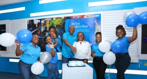 Jodi-Ann Richards (3rd R), the first Flow customer to be designated the 658 area code, is warmly welcomed by Flow team members at the Carlton store on Half-Way-Tree Road in St Andrew on Friday. With Richards, from left, are Donna Allison, Retail Stores Manager, Yanique Noble, Quality Monitor, Dwight Williams, Commercial Director, Mobile, Anna-Kay Coward, Retail Sales Advisor, and Koddine Henlan, Carlton Store Manager.