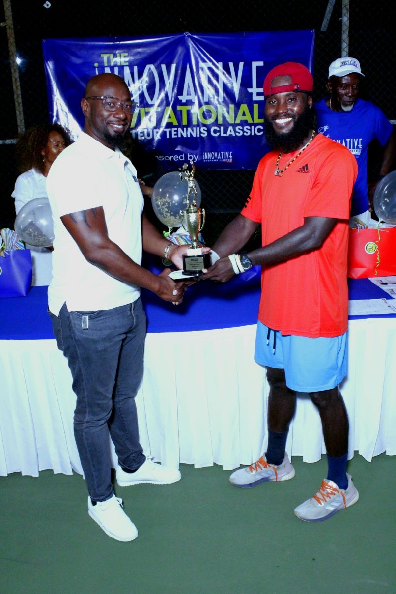 Garth Walker, Executive Chairman, Innovative Systems Limited, presents the winning prize to Jeremy Miller, winner of the Men's Open at the 2023 Innovative Invitational Amateur Tennis Classic finals at the Liguanea Club.