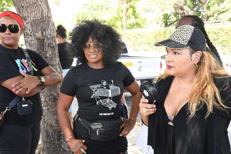 Singer Tanya Stephens (centre) and media personality Carlene "Dancehall Queen" Smith (right)join in the demonstration at Emancipation Park on Tuesday. 