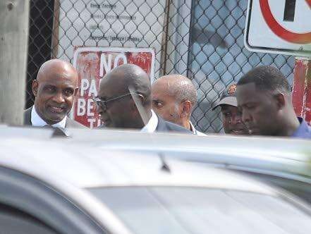 Former Education Minister Ruel Reid (second left) and CaribbeanMaritime University President Professor Fritz Pinnock (left) about toenter the Corporate Area Parish Court in Half-Way-Tree, St Andrewon October 10, 2019 for a bail hearing. Both men, along with Reid'swife Sharen and daughter Sharelle, as well as Jamaica Labour PartyCouncillor Kim Brown Lawrence are facing multiple charges in a multimillion-dollar fraud case.