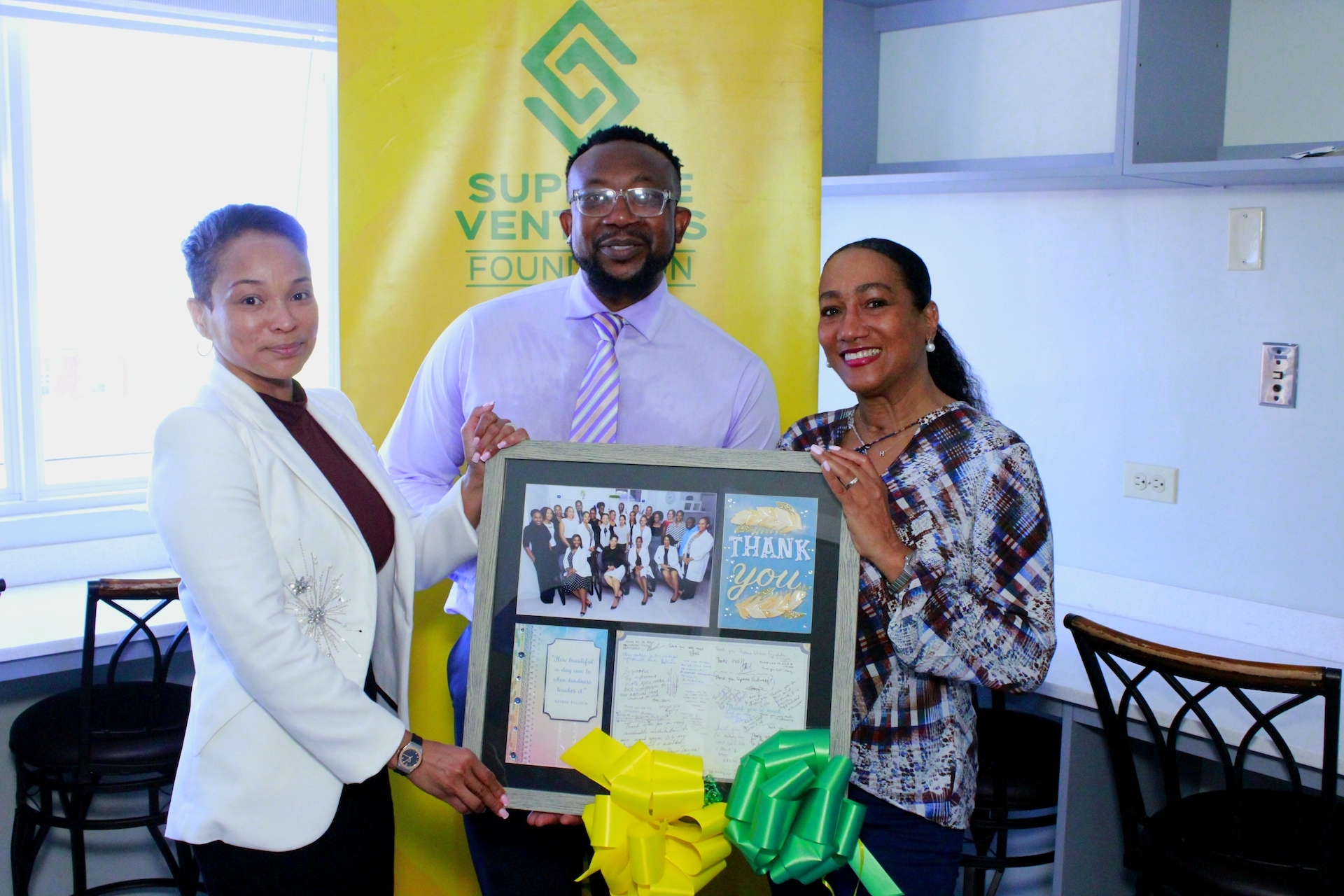 Supreme Ventures Foundation (SVF) Director and Chief Marketing Officer of Supreme Ventures Limited (SVL), Heather Goldson (right), receives a token on behalf of the Supreme Ventures Foundation for their renovation of the nurses' lounge at the Kingston Public Hospital (KPH). Dr. Marsha Chong, consultant Anaesthesia and Intensive Care (left), and Dr. Garth McDonald, Senior Medical Officer of Victoria Jubilee Hospital (center), present the token to her during the renovation tour at KPH on Friday.