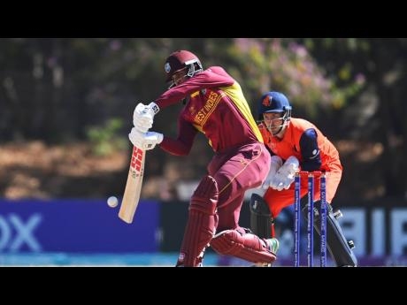 West Indies' Brandon King plays a shot during the ICC Men's Cricket World Cup Qualifier Zimbabwe 2023 match against the Netherlands at Takashinga Cricket Club today in Harare, Zimbabwe. Looking on is Netherlands wicketkeeper and captain, Scott Edwards.