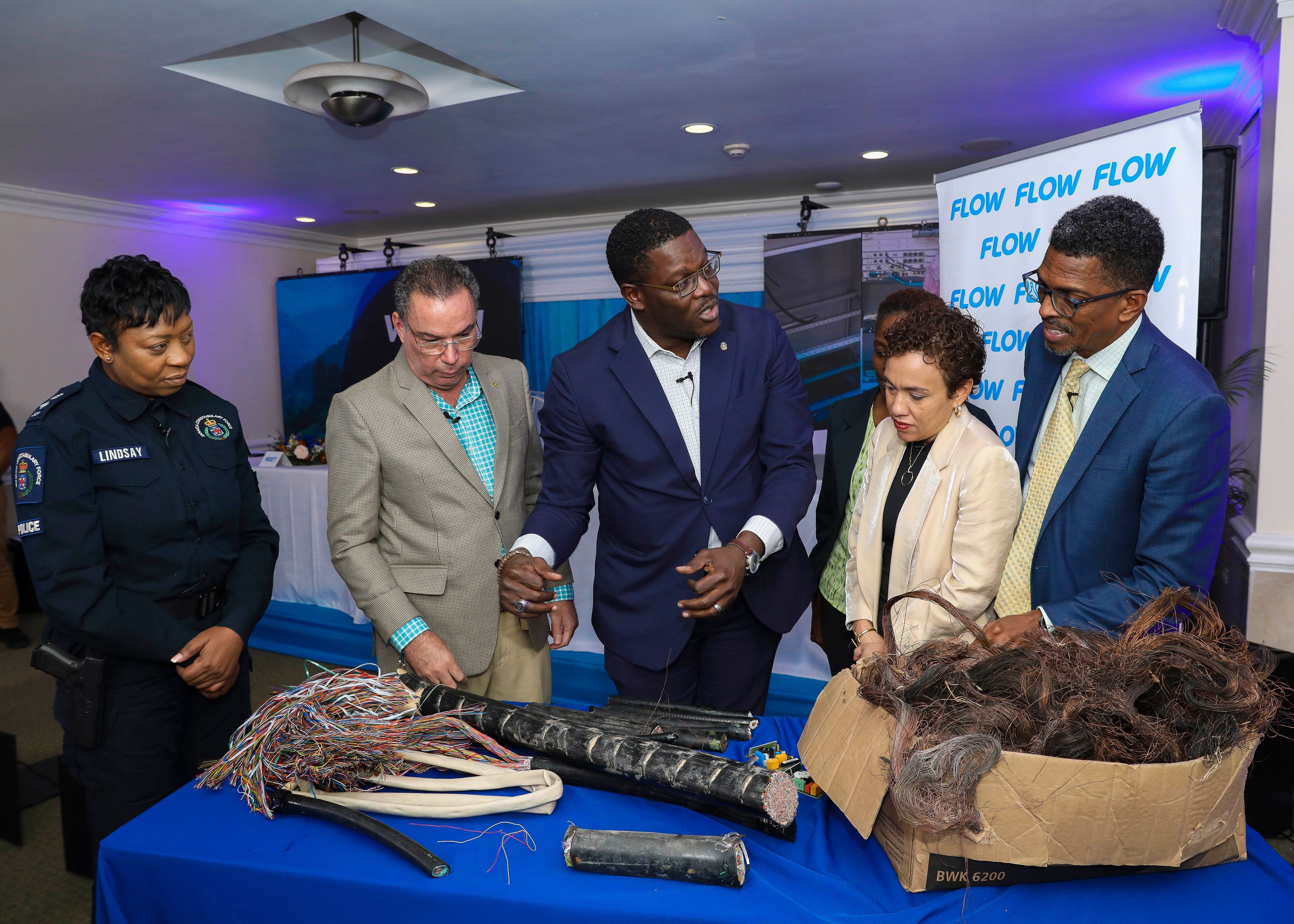 Public and Private stakeholders join Hon. Daryl Vaz, Minister, Science, Energy & Technology and Stephen Price, Vice President and General Manager of Flow Jamaica as they examine some of the cables impacted by theft and vandalism.  From left- right are: Head of the JCF’s Corporate Communications Unit (CCU), Senior Superintendent of Police (SSP) Stephanie Lindsay, Mrs. Carolyn Ferguson Arnold, Consumer Advisory Committee on Utilities (CACU), OUR, Mrs. Jacqueline Sharp, Vice President, The Private Sector Organisation of Jamaica (PSOJ) and Mr. Ian Neita, Immediate Past President of the Jamaica Chamber of Commerce (JCC). 