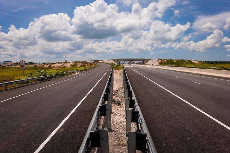 Prime Minister Andrew Holness (left) and Everald Warmington, the minister without portfolio in the Ministry of Economic Growth and Job Creation with responsibility for works, walk on a section of the May Pen to Williamsfield leg of Highway 2000 after it was officially opened Thursday morning.