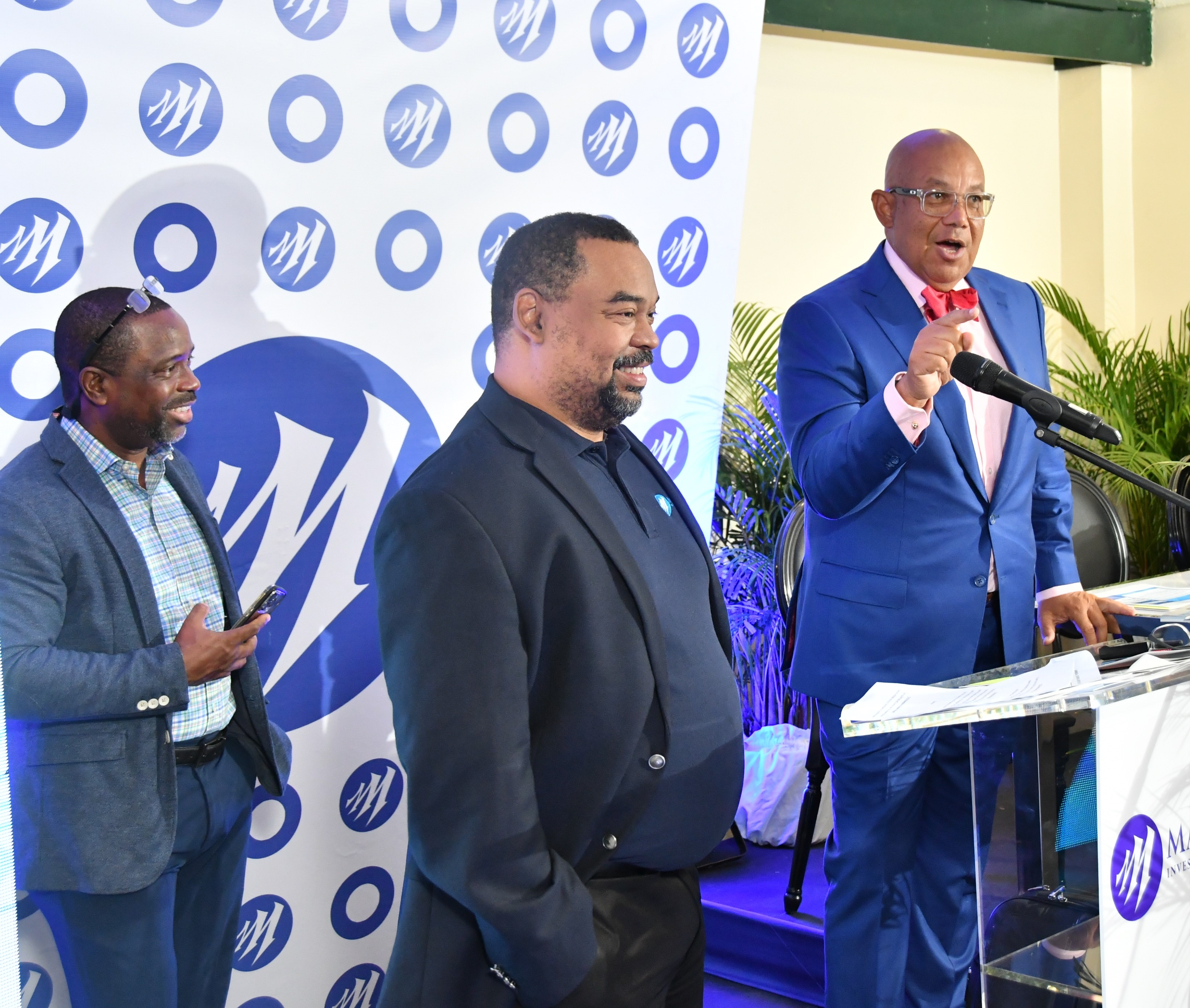 Chris Berry (right), Chairman of Mayberry Group Limited (MGL), and Gary Peart (left), CEO of MGL, stand united, along with Dan Theoc (background), Mayberry’s VP of Investment Banking (background).