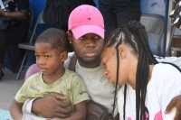 Danielle Rowe&#039;s little brother Jamari Taylor (left), cousin Kevon Rowe, and mother Sudiene Mason are a picture of grief during morning devotion at Braeton Primary and Infant School on Monday.
