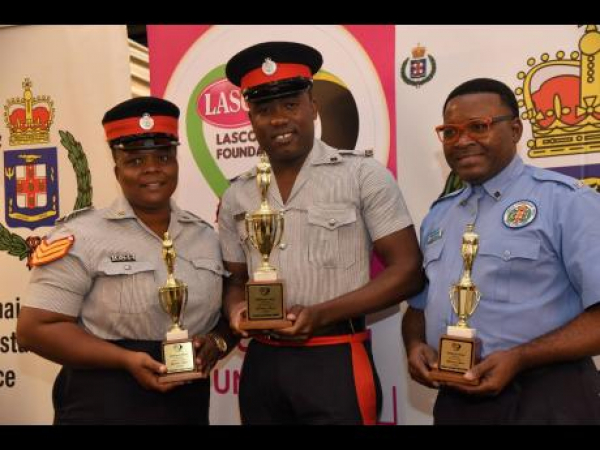 Corporal Rohan Smith (centre) shows off his trophy after winning the LASCO/Jamaica Constabulary Force (JCF) Police Officer of the Year Award. He is joined by first runner-up Alsian Clayton (left) and second runner-up Alfred Palmer. The award ceremony was held at the AC Marriott Hotel in Kingston on Friday, October 28.