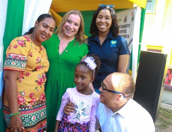 (Left to right in the front row) Cardiac patient Oneila Dunn stands alongside Dr. the Honourable Christopher Tufton at the Chain of Hope Thank You Event on Thursday. Joining the heartfelt moment at the Bustamante Hospital are (from left to right) mother Kina-Gay Brown, Emma Scanlan, Executive Director of Chain of Hope, and Tashoni Ellis, Marketing Manager at Dolla Financial