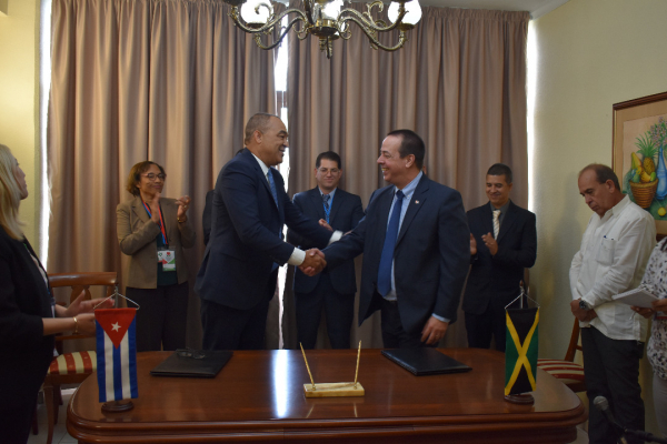 Minister of Health and Wellness, Dr. the Hon. Christopher Tufton and Minister of Public Health of Cuba, Dr. José Angel Portal Miranda shake hands following the signing of the letters of intent.