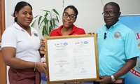 Chief Executive Officer, Everton Anderson [right], Camille Abrahams Anderson, pharmacy services director – SERHA Northwest [left], and Chief Pharmacist – BHC [center] proudly display the Certificate of Conformity from NCBJ in May 2023.