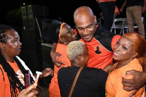 Dr Alfred Dawes is embraced by comrades supporting his campaign for Member of Parliament for St Catherine South Eastern