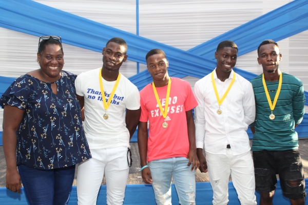 (from left to right) Parent manager (volunteer) Opal Martin poses with St. George&#039;s College athletes, Class 2 4x100m finalists Tyreece Foreman, Antwone Bygrave, Raheem Collins, and Kaheem Williams, during the recent award ceremony, with the support of Mayberry Investments Limited, celebrating the achievements of the St. George&#039;s College track and field athletes who participated in Champs and other sporting events throughout the season.