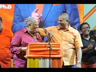 Mikael Phillips (right), member of parliament for Manchester North Western, welcomes his father, Dr Peter Phillips, former president of the People’s National Party, to the podium at the East Central St Andrew Annual Constituency Conference at Jacisera Park.